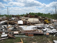 Another view of damage to the church. A lone pew and podium can be seen still standing in the damage area. ~ 855 kb